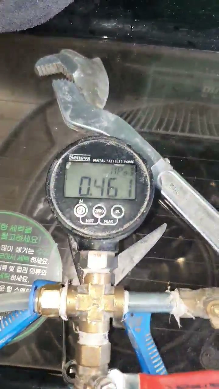 배관에 디지털 압력계를 연결해 압력을 겁니다 — 현장 영상에서 수치가 0.461에서 0.458 MPa로 내려갑니다